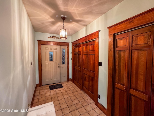 entryway with light tile patterned floors