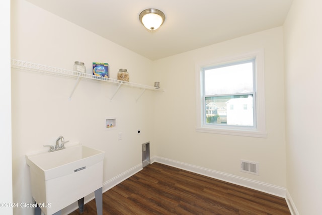 washroom with hookup for an electric dryer, sink, washer hookup, and dark hardwood / wood-style floors