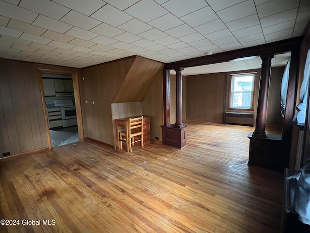 bonus room featuring light hardwood / wood-style floors and wood walls