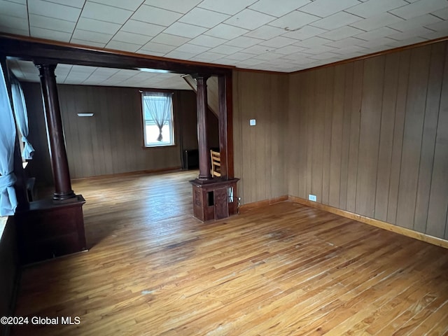 unfurnished living room featuring light hardwood / wood-style floors and wood walls