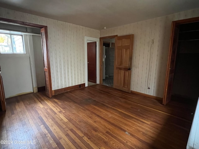 unfurnished bedroom with dark hardwood / wood-style floors