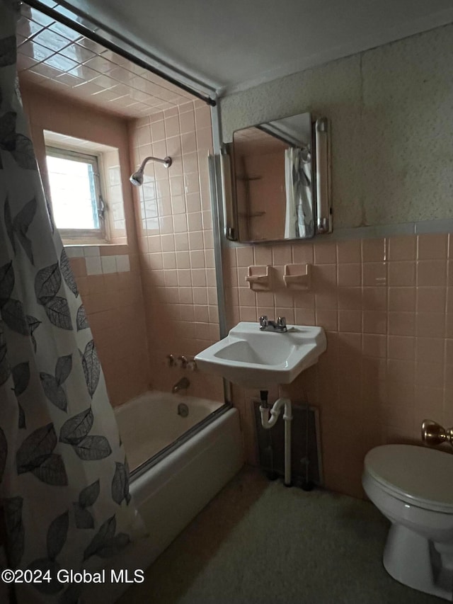 bathroom featuring tile walls, toilet, and shower / bath combination with curtain