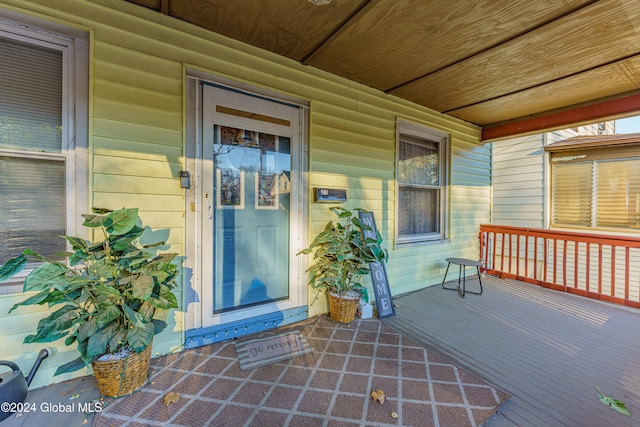 view of exterior entry featuring covered porch