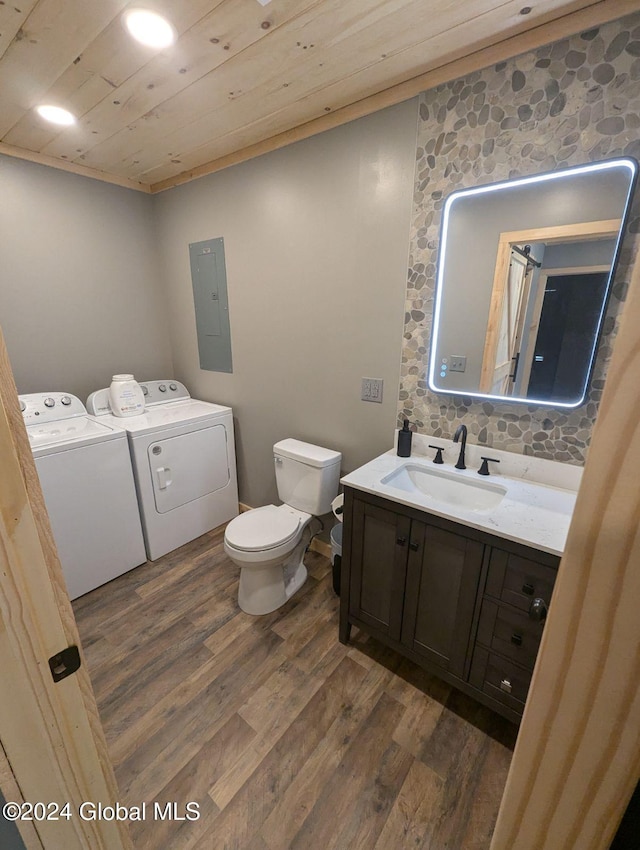 bathroom with electric panel, wood-type flooring, wood ceiling, vanity, and washer and dryer