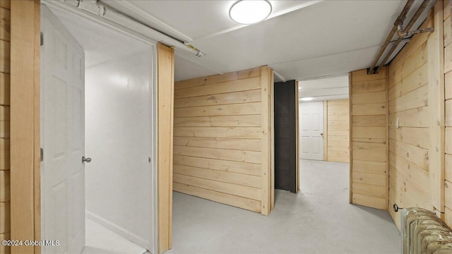 corridor featuring wood walls