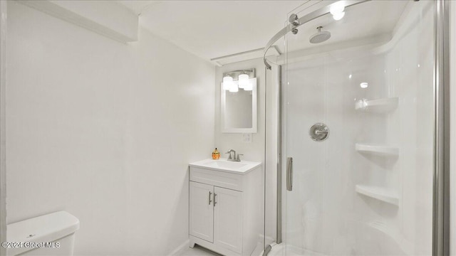 bathroom featuring vanity, toilet, and a shower with door