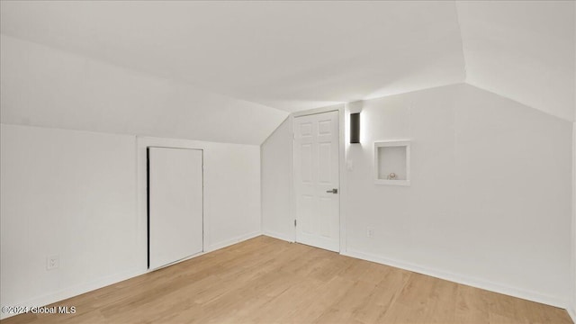 bonus room featuring light hardwood / wood-style floors and lofted ceiling