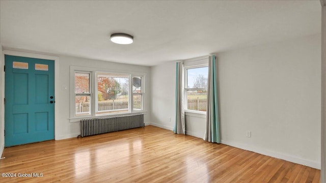 interior space with light hardwood / wood-style flooring and radiator