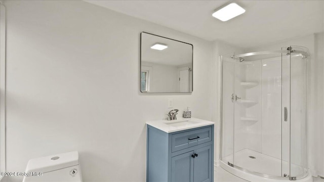 bathroom featuring an enclosed shower, vanity, and toilet