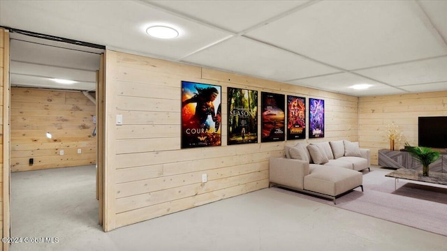 living room with wooden walls and concrete floors