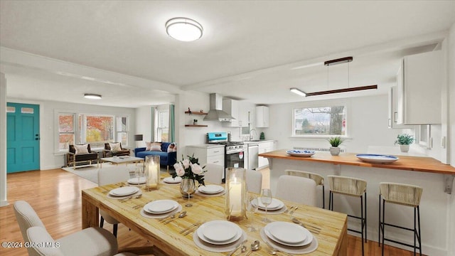 dining space with light hardwood / wood-style floors and sink