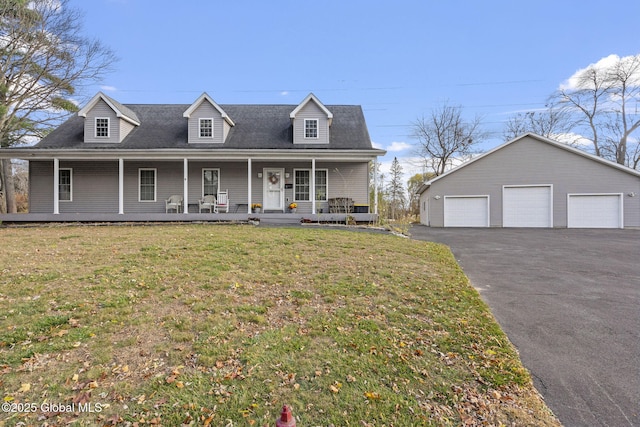 cape cod house with a garage, covered porch, an outbuilding, and a front lawn