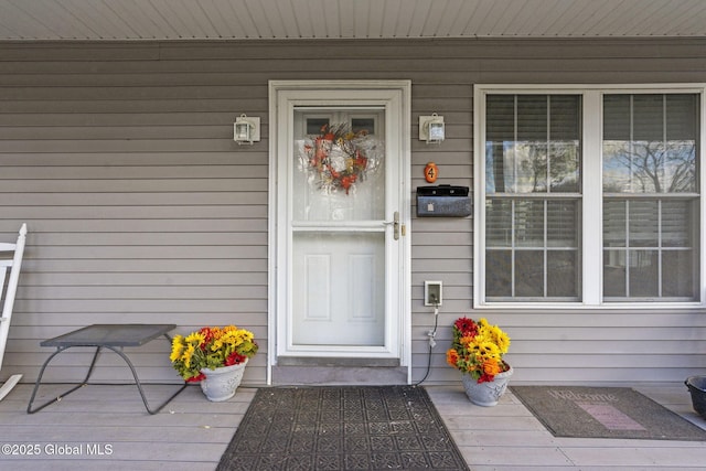 view of exterior entry featuring covered porch