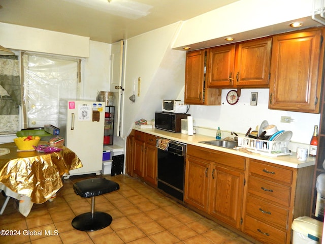 kitchen featuring light tile patterned flooring and black appliances