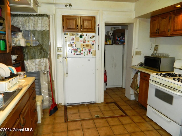 kitchen with light tile patterned floors and white appliances