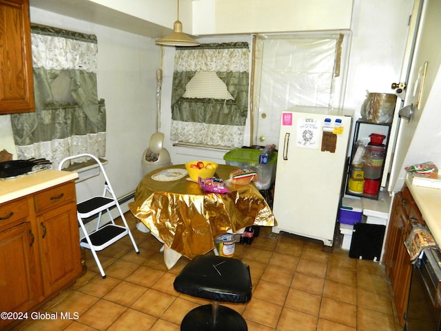 kitchen featuring white refrigerator and dark tile patterned floors