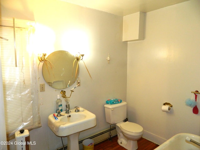 bathroom with wood-type flooring, toilet, and a baseboard heating unit