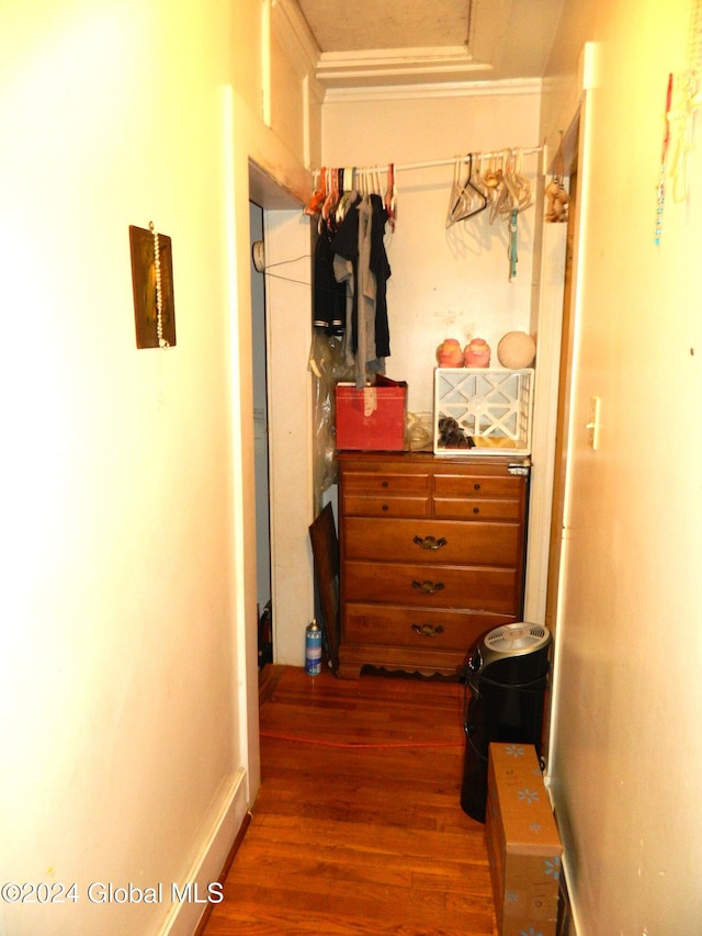 hallway with ornamental molding and dark hardwood / wood-style floors