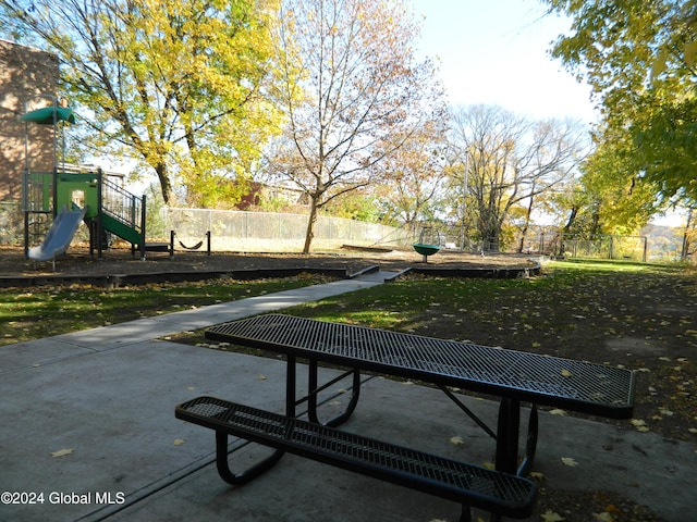 view of home's community featuring a yard and a playground