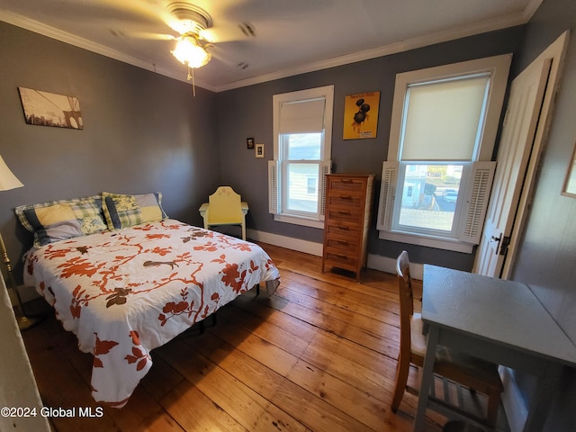 bedroom with hardwood / wood-style floors, ceiling fan, and crown molding