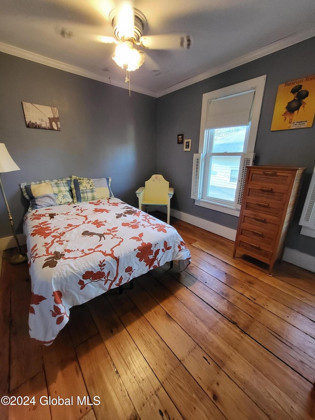 bedroom with hardwood / wood-style flooring, ceiling fan, and crown molding