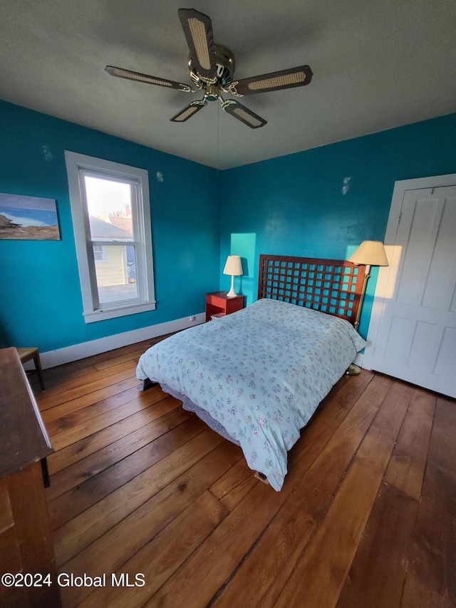 bedroom with hardwood / wood-style floors and ceiling fan