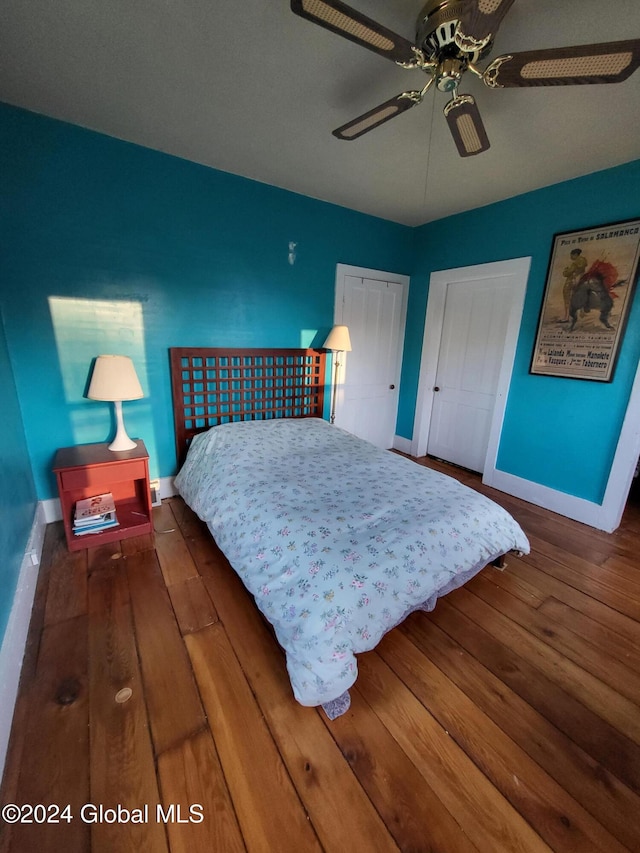 bedroom with ceiling fan and dark hardwood / wood-style floors