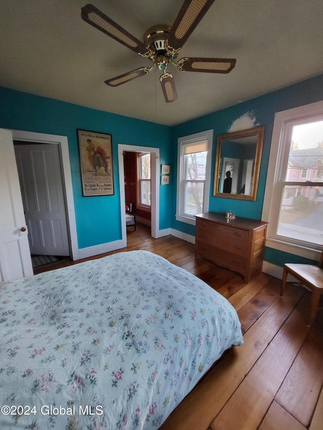 bedroom featuring hardwood / wood-style floors, ceiling fan, and a closet