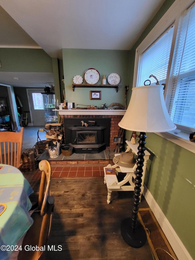 living room featuring a wood stove and wood-type flooring