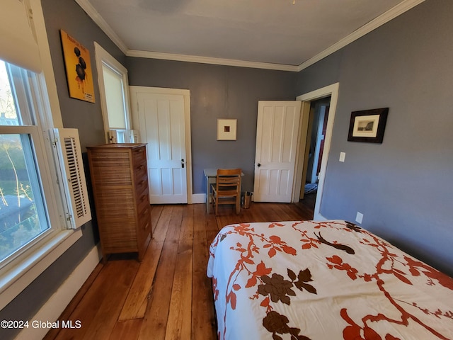 bedroom with dark hardwood / wood-style flooring and crown molding