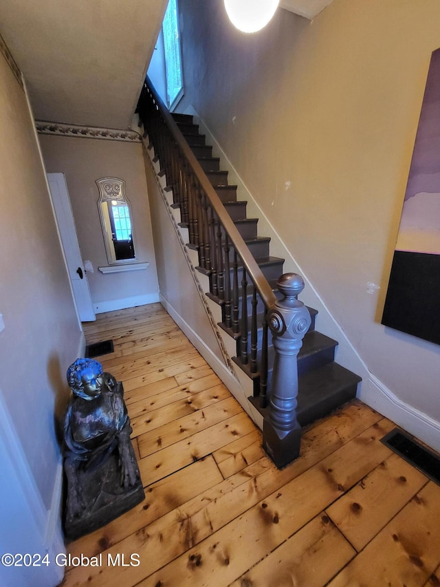 stairway with hardwood / wood-style flooring