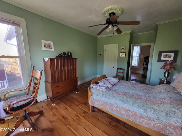 bedroom with ceiling fan, light wood-type flooring, and ornamental molding