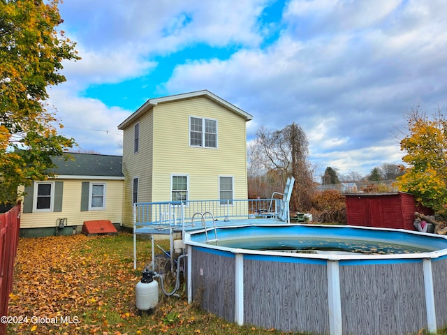 back of house featuring a pool side deck