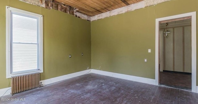 75 E Main St, Johnstown, NY 12095 - unfurnished room featuring radiator, wooden ceiling, and wood finished floors