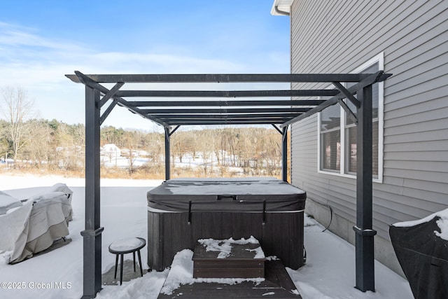 snow covered patio featuring a hot tub