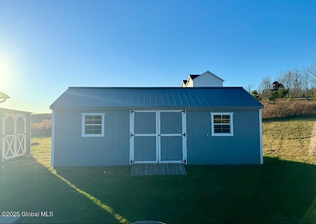 view of outbuilding featuring a yard