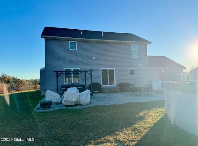 back of house with a patio and a lawn