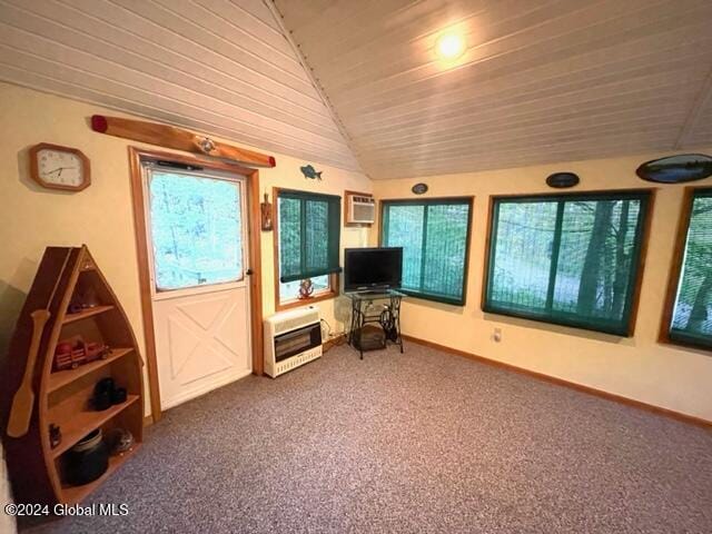 interior space with wooden ceiling, a wall unit AC, heating unit, and vaulted ceiling