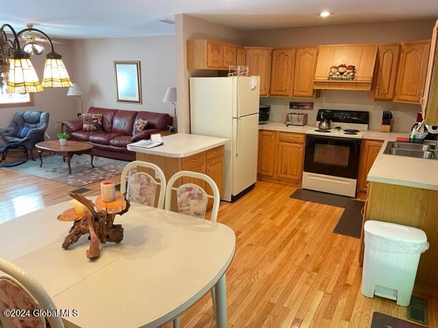 kitchen featuring light hardwood / wood-style flooring, sink, and white appliances