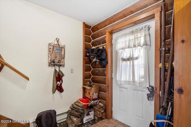 entryway with baseboard heating and a textured ceiling