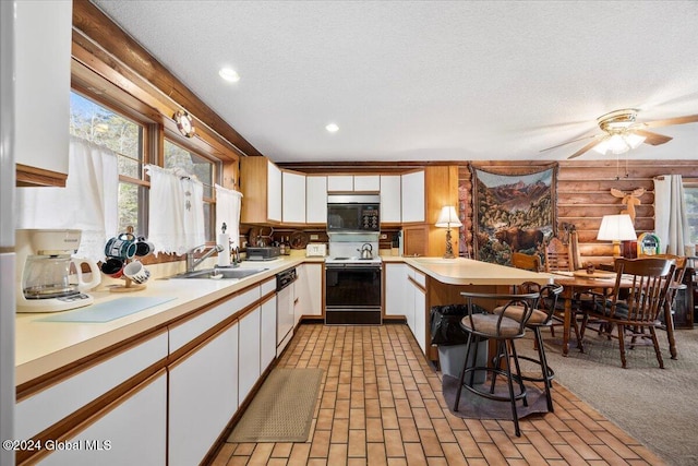 kitchen with dishwasher, sink, kitchen peninsula, electric range, and white cabinetry