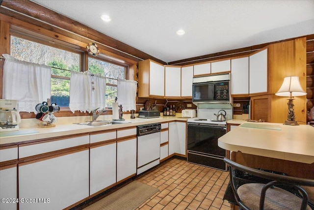 kitchen with white cabinetry, white appliances, and sink