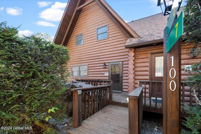 back of property with a wooden deck