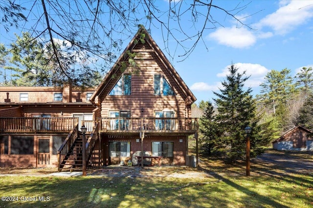 back of property featuring a yard and a wooden deck