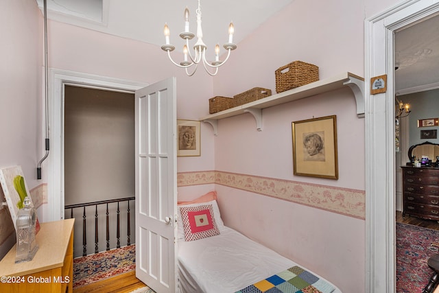 bedroom featuring a chandelier and wood-type flooring