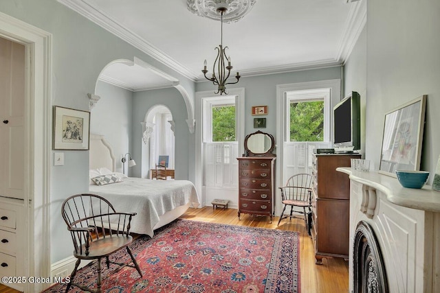 49A Dove St, Albany, NY 12210 - bedroom featuring arched walkways, light wood finished floors, crown molding, and baseboards