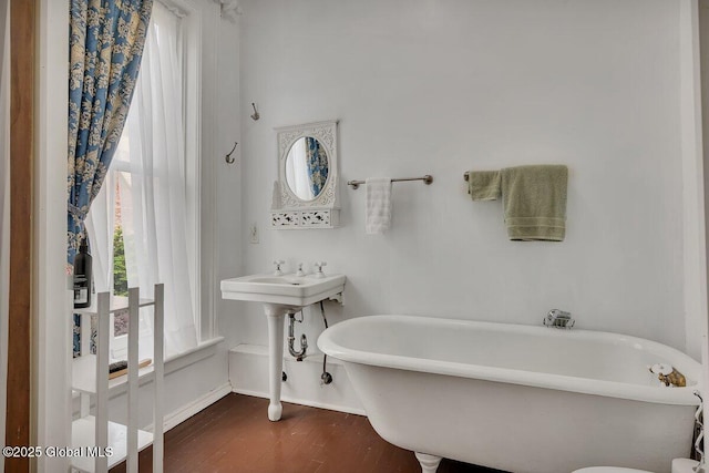 49A Dove St, Albany, NY 12210 - bathroom featuring baseboards, wood finished floors, and a soaking tub