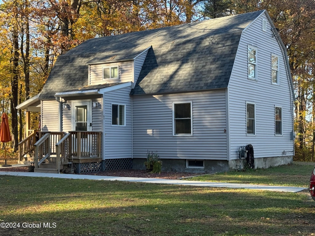 rear view of property with a lawn