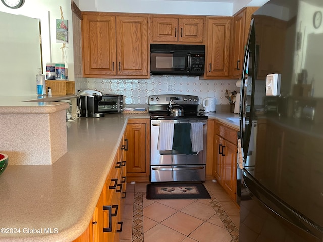 kitchen with black appliances and light tile patterned floors