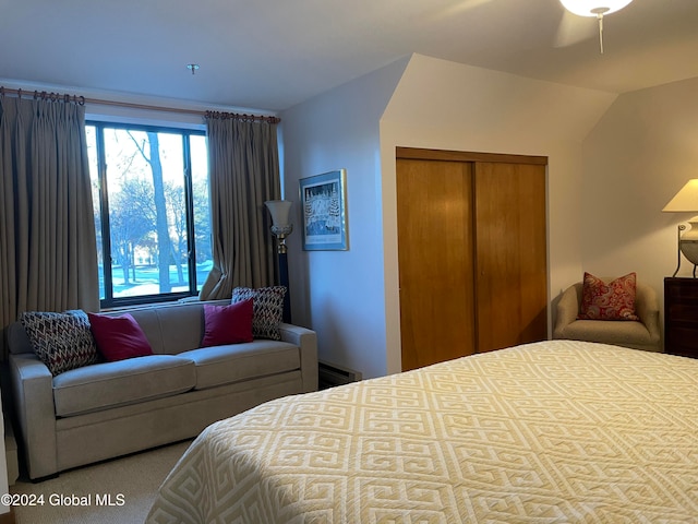 carpeted bedroom featuring vaulted ceiling and a closet